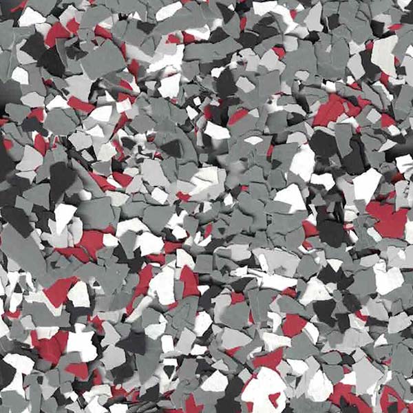 The image shows a scattered pattern of randomly shaped flakes in shades of gray, white, black, and red, resembling a close-up of gravel.