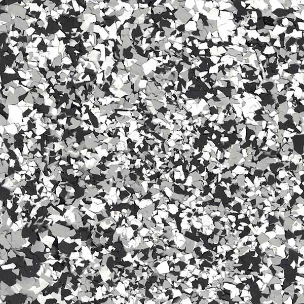 The image shows a close-up of a terrazzo flooring pattern with black, white, and grey chips evenly dispersed across the surface.