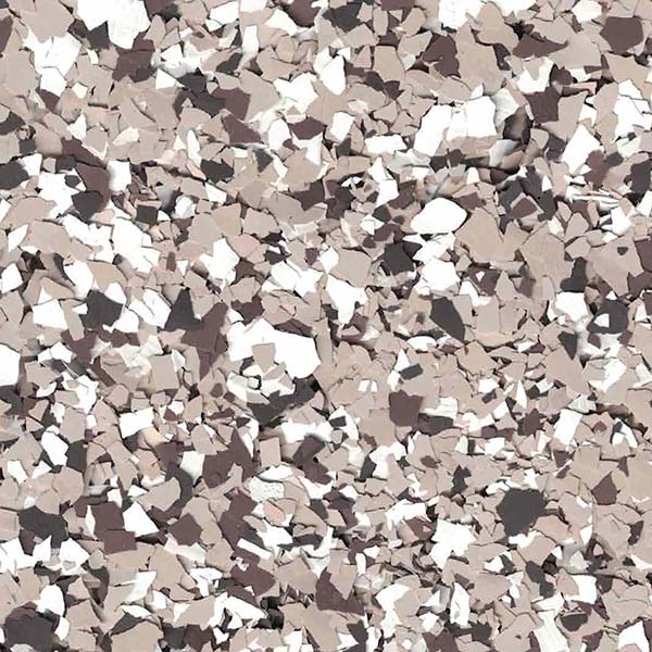 The image displays a close-up of a textured surface with scattered, multicolored chips in shades of brown, beige, black, and white.