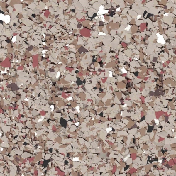 The image shows a close-up view of multi-colored, irregularly shaped flakes, predominantly in beige, brown, and red hues, resembling an abstract pattern.