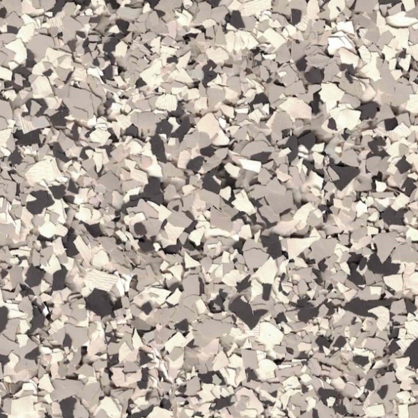 The image shows a close-up of a speckled, textured surface in shades of white, beige, and gray, resembling scattered, irregular particles.