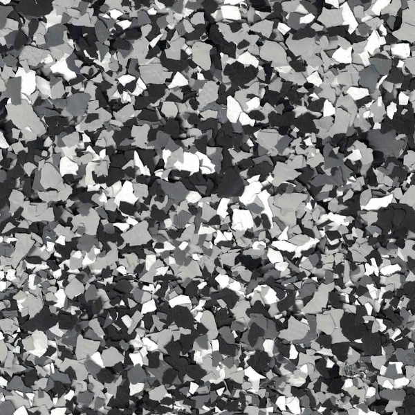 A close-up of a black and white terrazzo floor with random fragments distributed evenly throughout, creating a speckled, mosaic-like pattern.